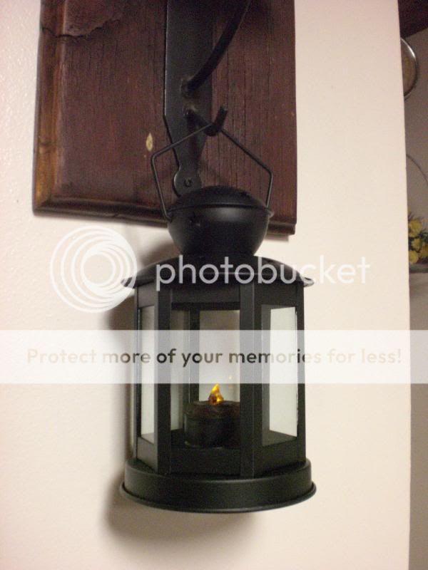 This is a primitive black lantern that measures 7 1/2 inches tall by 4 